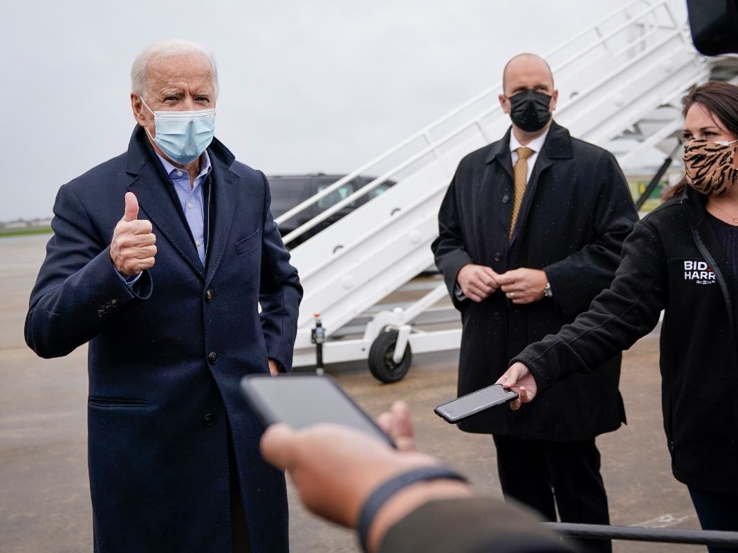 Democratic presidential nominee Joe Biden speaks to reporters before boarding his campaign plane at New Castle Airport on October 30, 2020 in New Castle, Delaware. Biden is campaigning in Iowa, Wisconsin and Minnesota on Friday. 