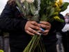 A woman holds flowers during a vigil for Daunte Wright on April 12, 2021 in Brooklyn Center, Minnesota. 