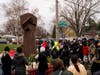 People gather around a sculpture of a raised fist during a vigil for Daunte Wright on April 12, 2021 in Brooklyn Center, Minnesota. The fist sculpture first appeared over the summer at the memorial for George Floyd, the artist Jordan Powell-Karis brought