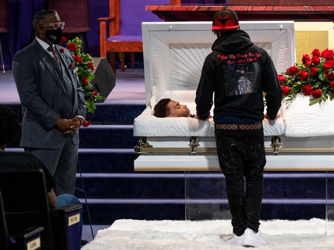 Emajay Driver stands before the casket of Daunte Wright during a wake at Shiloh Temple International Ministries church on April 21, 2021 in Minneapolis, Minnesota.