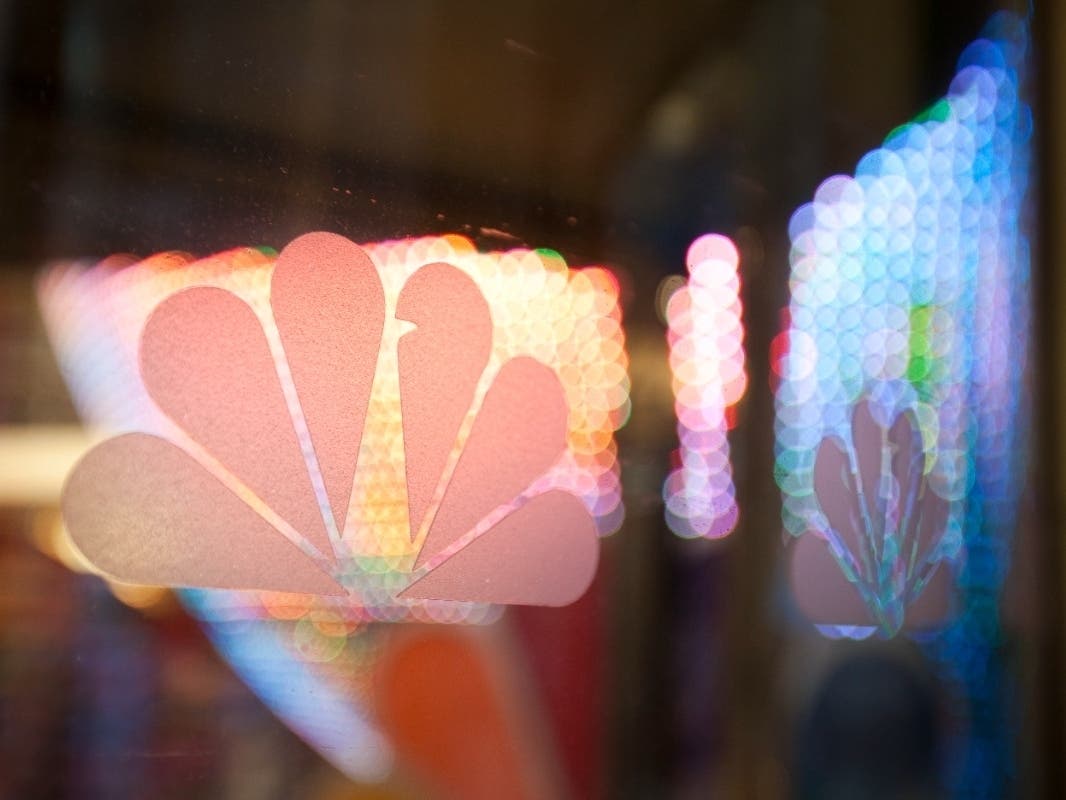he NBC peacock logo is seen on the door to the NBC Experience Store at Rockefeller Center on December 1, 2009 in New York City.