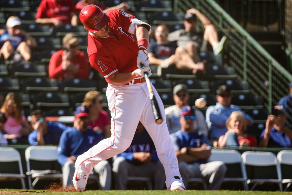 Mike Trout #27 of the Los Angeles Angels lines out in the spring training game against the Texas Rangers at Tempe Diablo