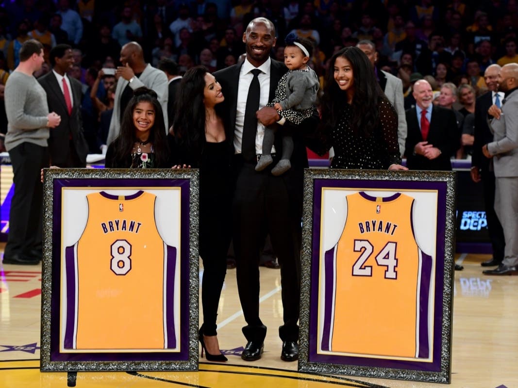 Kobe Bryant poses with his family at halftime after both his #8 and #24 Los Angeles Lakers jerseys are retired at Staples Center on December 18, 2017 in Los Angeles, California. 