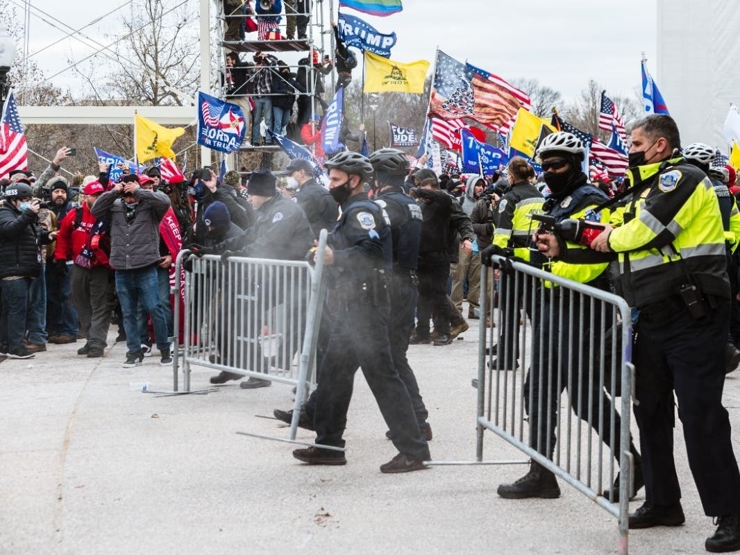 A large group of pro-Trump protesters face off against police with pepper spray after protesters storm the grounds of the Capitol Building on January 6, 2021 in Washington, DC.