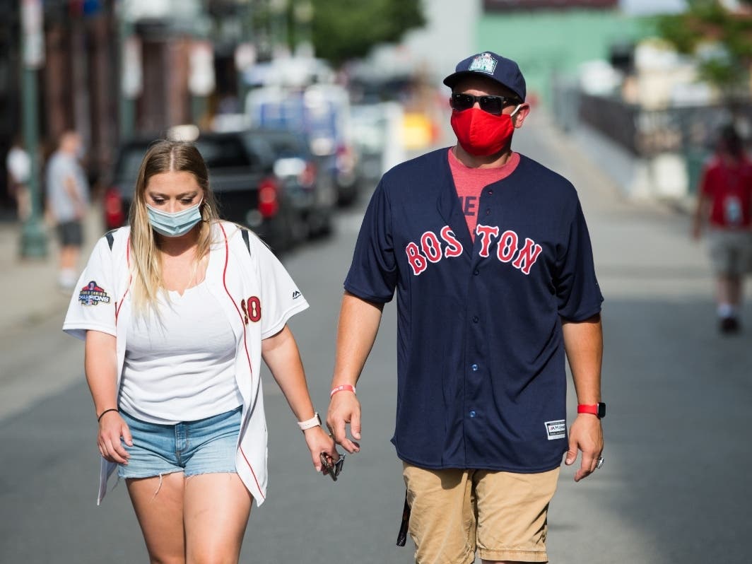 Fans wear masks on Landsdowne Street prior to the start of the Boston Red Sox-Baltimore Orioles game July 24.