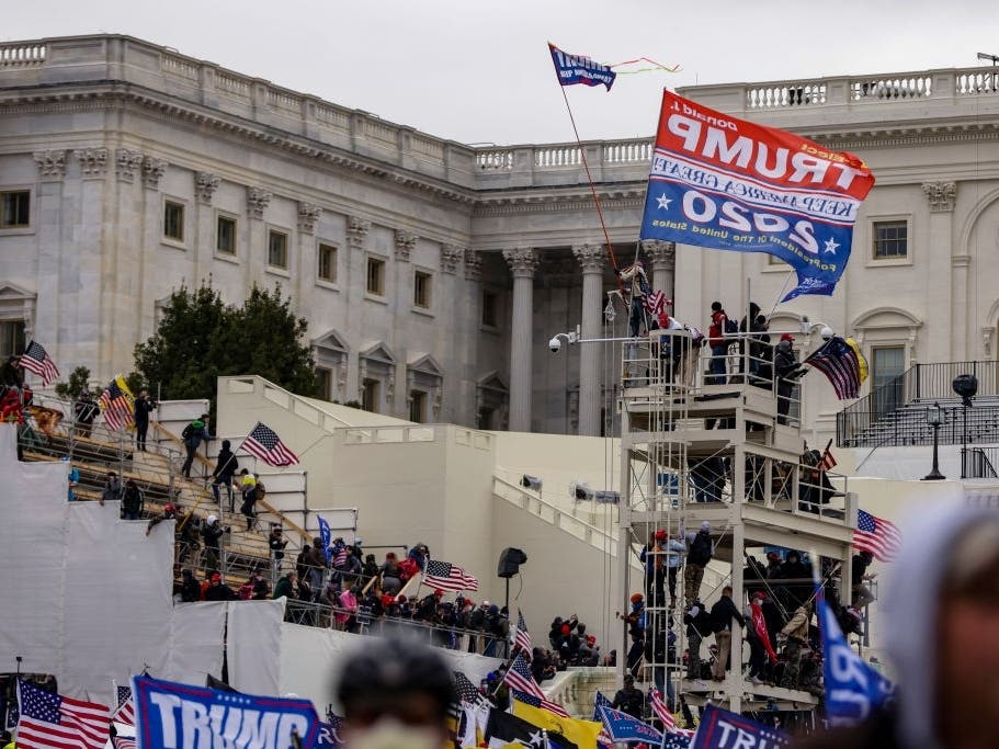 Pro-Trump supporters storm the U.S. Capitol following a rally with President Donald Trump on Jan. 6 in Washington. Natick Town Meeting member Suzanne Ianni is facing three charges connected to the incident. 