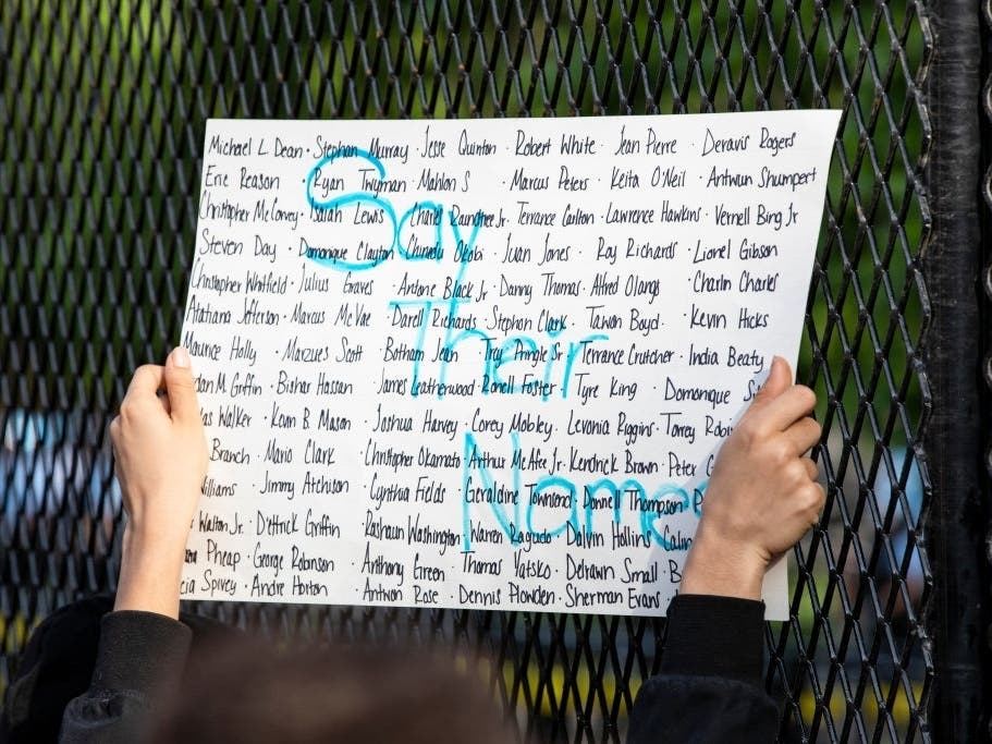 A protestor holds a sign listing victims of police violence during a demonstration across the street from the White House over the death of George Floyd, who died in police custody, on June 2, 2020 in Washington, DC. 