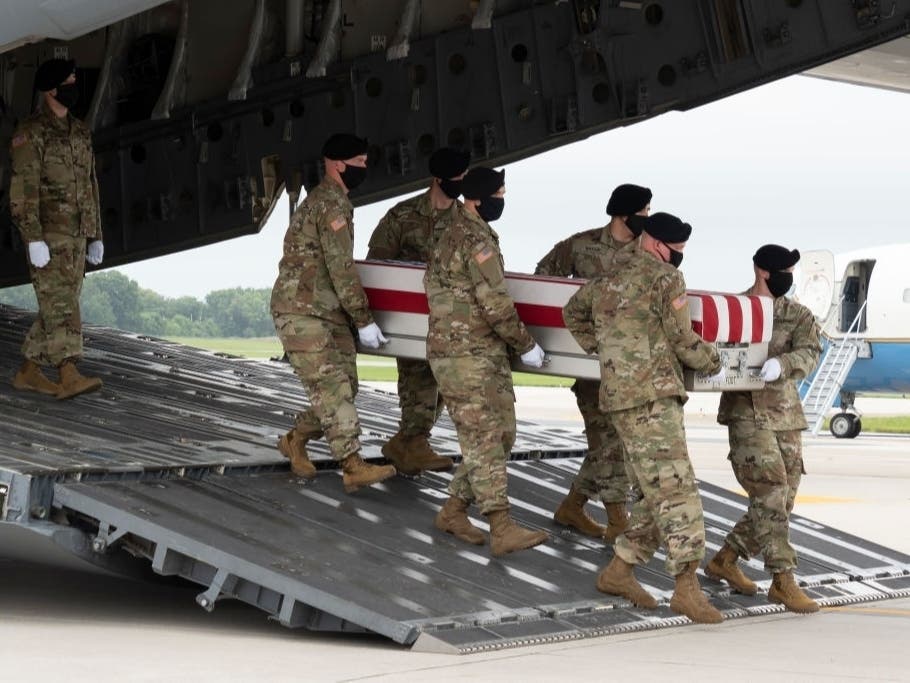 In this photo provided by the U.S. Air Force, a U.S. Army carry team transfers the remains of Army Staff Sgt. Ryan C. Knauss of Corryton, Tennessee, Aug. 29, 2021 at Dover Air Force Base, Delaware. NoVA first responders honored his funeral procession.