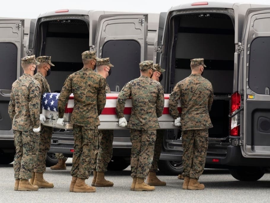 A U.S. Marine Corps carry team transfers the remains of Marine Corps Sgt. Nicole L. Gee on Aug. 29 at Dover Air Force Base, Delaware. 