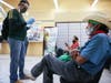Faustino (R) and Antonio (L), who are both unemployed, wait after filling out unemployment forms in a bookkeeping shop near the U.S.-Mexico border in Imperial County, which has been hard-hit by the COVID-19 pandemic, on July 24, 2020 in Calexico, Calif.