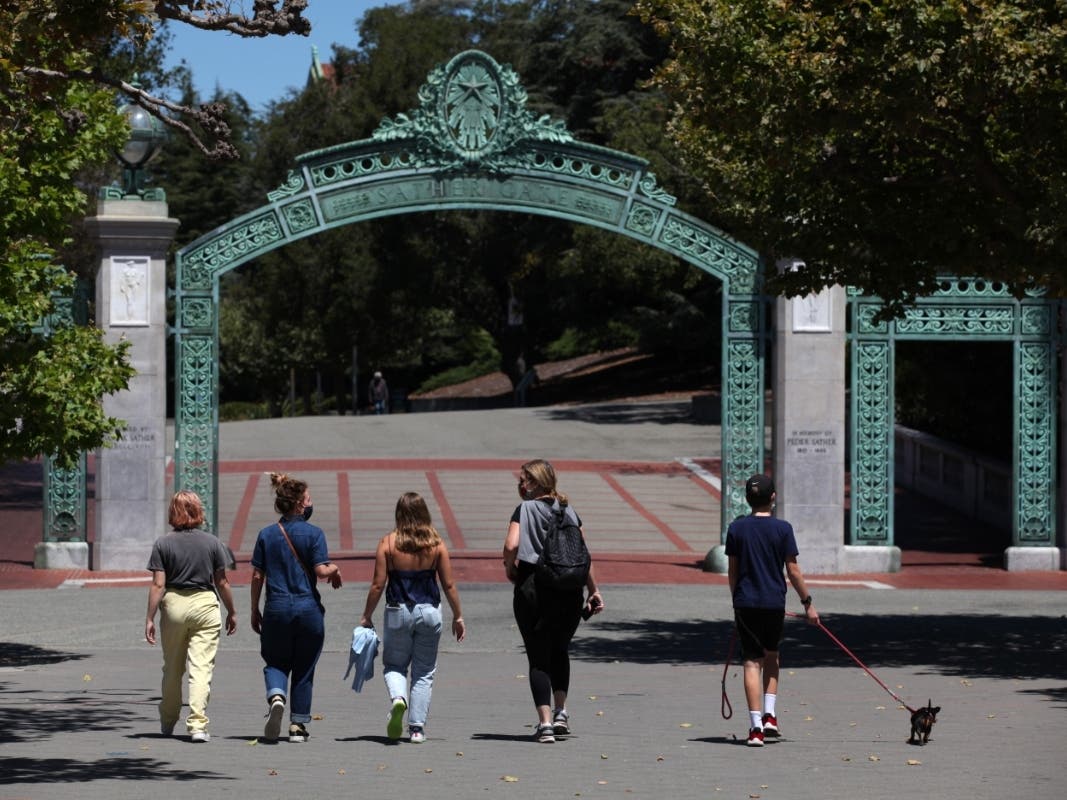 BERKELEY, CALIFORNIA - JULY 22: People walk towards Sather Gate on the U.C. Berkeley campus on July 22, 2020 in Berkeley, California. 