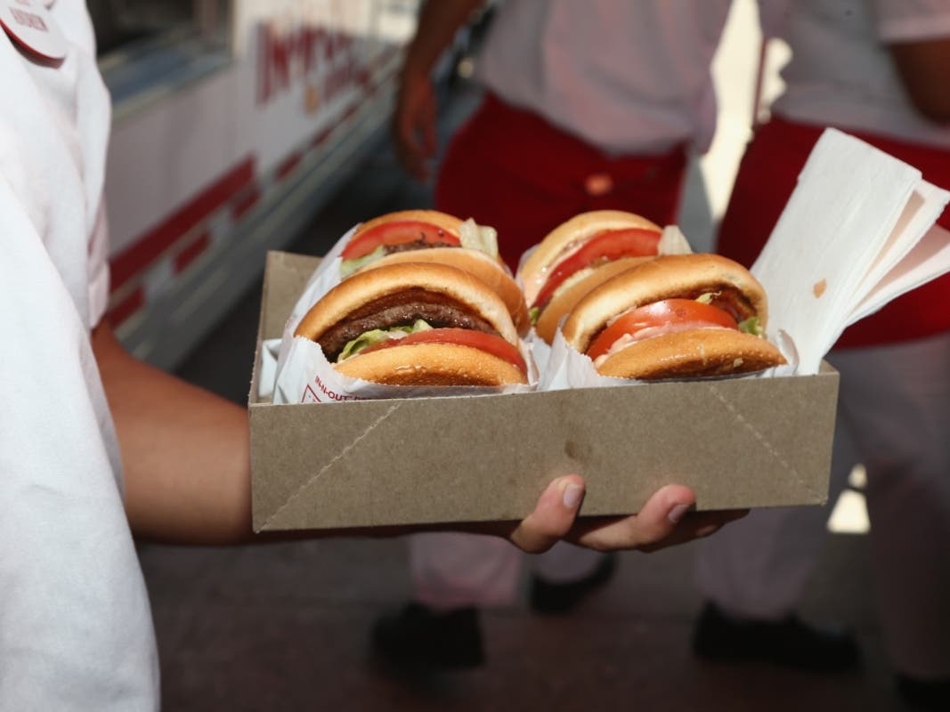 A group of animal rights activists rallied in and around the Fisherman's Wharf In-N-Out location on Saturday to demand greater clarity on the fast food chain's beef suppliers.