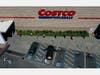 In this aerial view from a drone, shoppers practice social distancing waiting in line to enter a Costco store on April 13, 2020 in Novato, California.