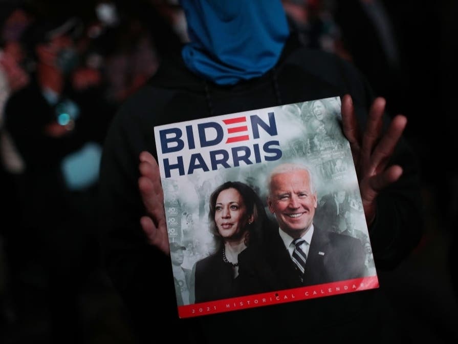  A person holds a calendar with the faces of U.S. Vice President-elect Kamala Harris and President-elect Joe Biden as they address the nation at the Chase Center in Wilmington, DE.