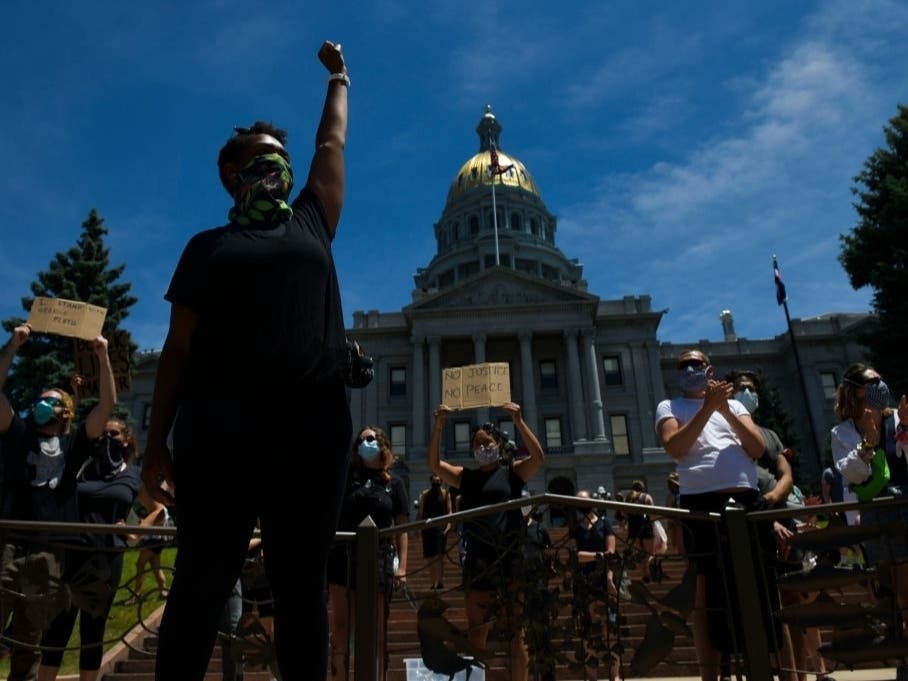  Lywanna Melvin raises her fist near the state Capitol during the fifth consecutive day of demonstrations in the aftermath of the death of George Floyd.