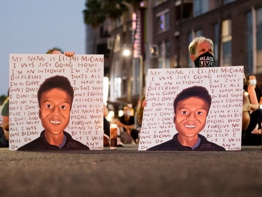 People gather at a candlelight vigil in California to demand justice for Elijah McClain on the one year anniversary of his death. Colorado's attorney general is launching a grand jury investigation into his death.