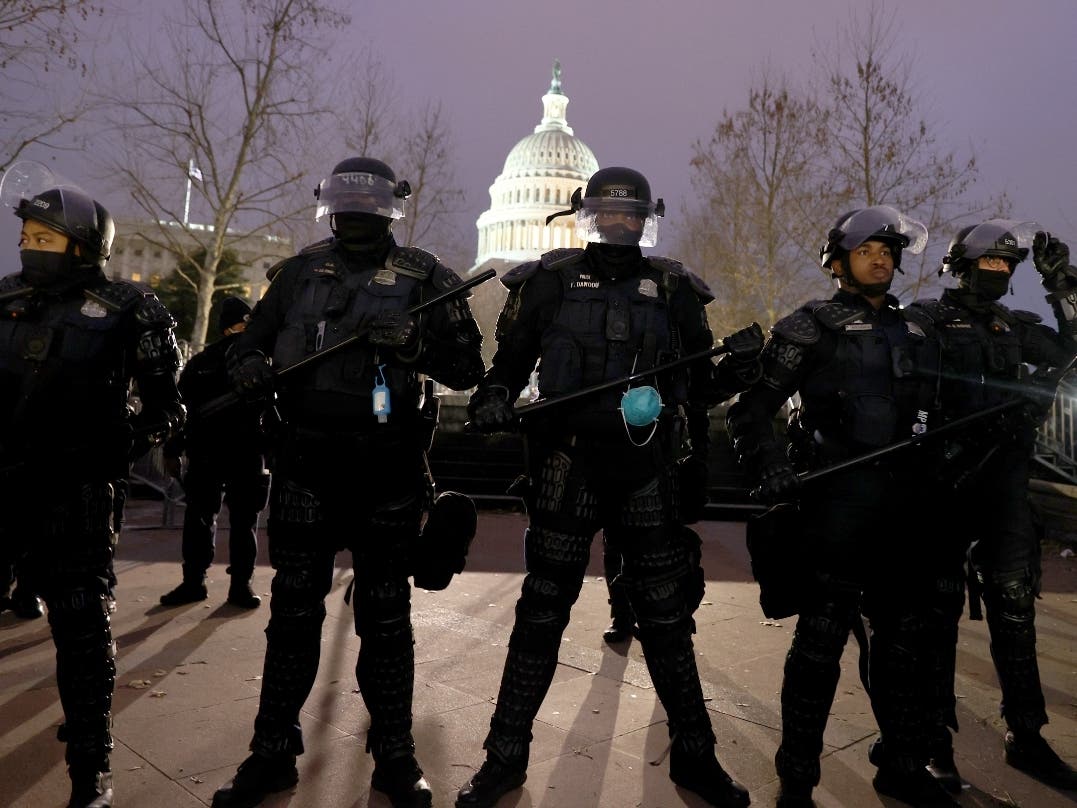 Police officers in riot gear line up as protesters gather at the U.S. Capitol on Wednesday.