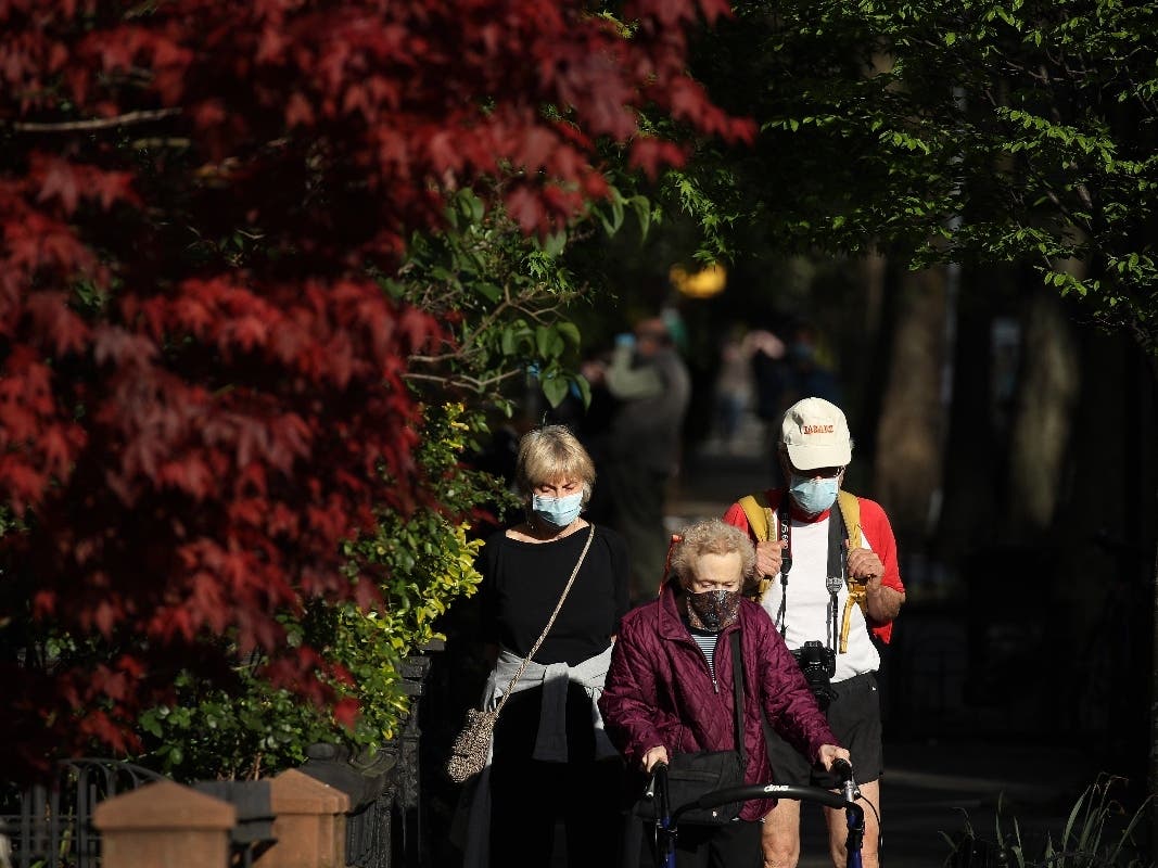 NEW YORK, NY - MAY 02: Pedestrians, wearing protective face masks walk through Park Slope during the coronavirus pandemic on May 02, 2020 in the Brooklyn borough of New York City.