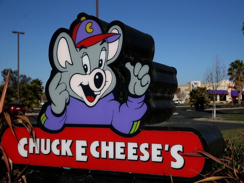 A sign posted in front of a Chuck E. Cheese in California.