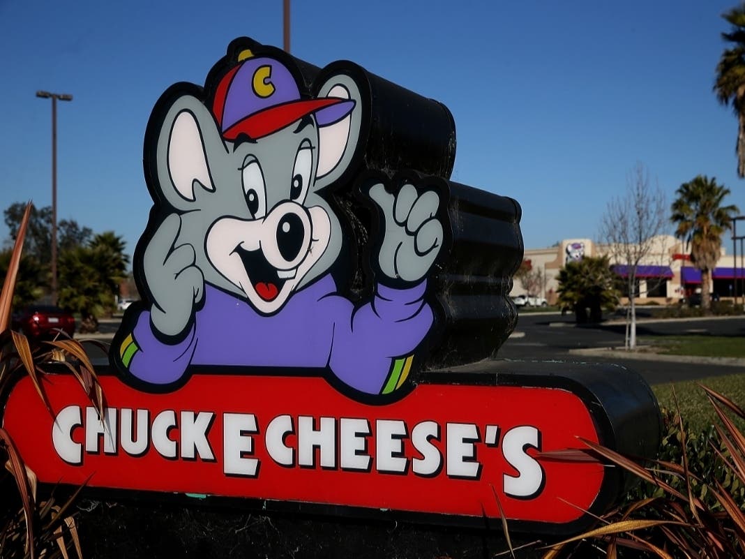 A sign posted in front of a Chuck E. Cheese in California. 