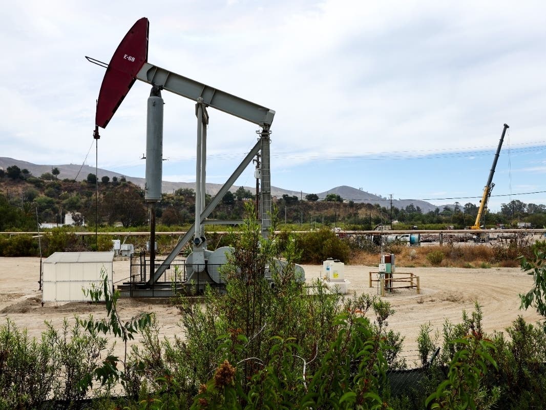 An oil pumpjack operates in California. The Inflation Reduction Act of 2022 holds provisions for climate change, including tax incentives for clean energy production, while also benefitting the oil industry.