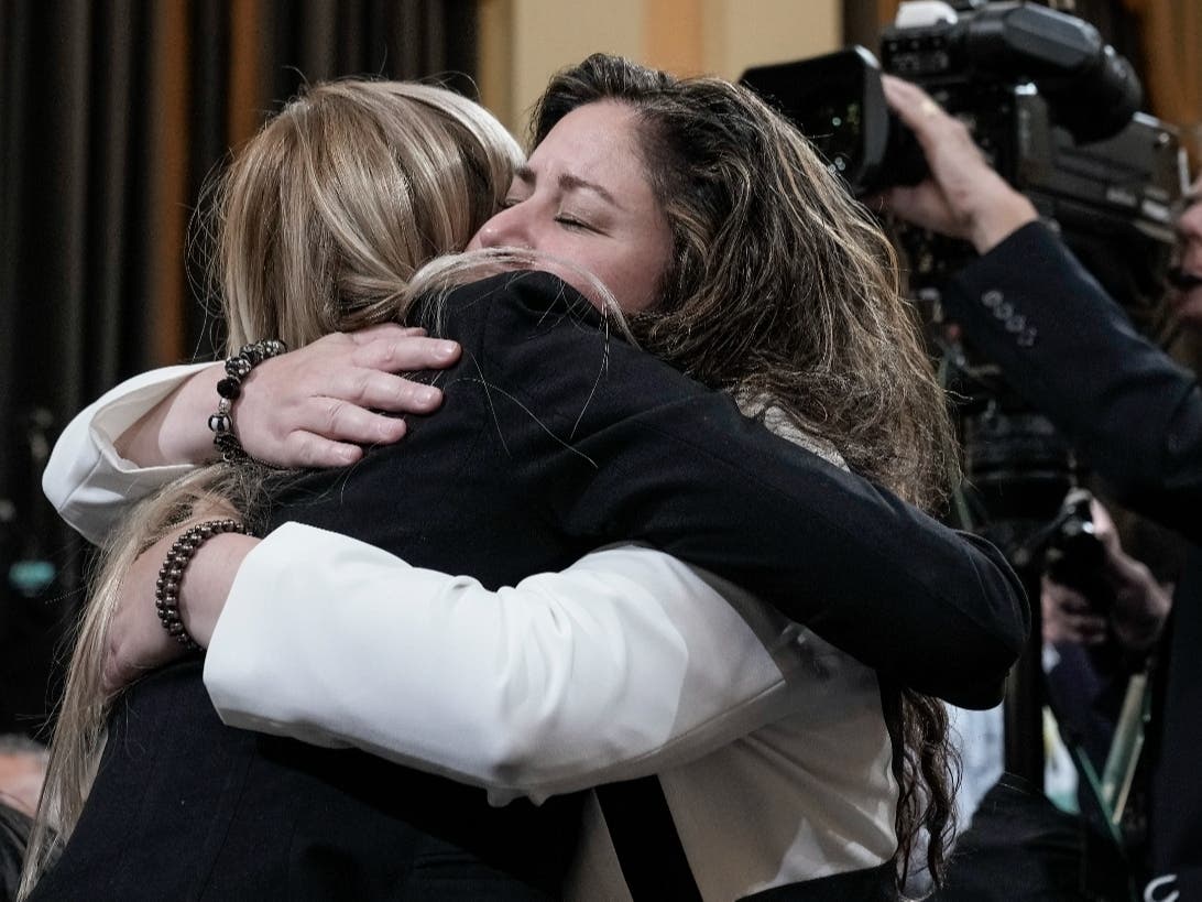 Sandra Garza, right, the longtime partner of Capitol Hill Police Officer Brian Sicknick who died after the Jan. 6 riot, embraces U.S. Capitol Police Officer Caroline Edwards on June 9 after Edwards testified to the House's Jan. 6 select committee.