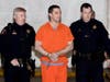 Convicted murderer Scott Peterson is escorted by two San Mateo County Sheriff deputies as he is walked from the jail to an awaiting van March 17, 2005 in Redwood City.