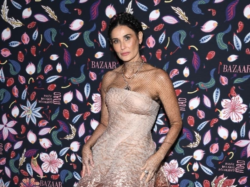 An identity thief was sentenced to 14 months in a halfway house today for helping a co-defendant use Demi Moore's American Express card.