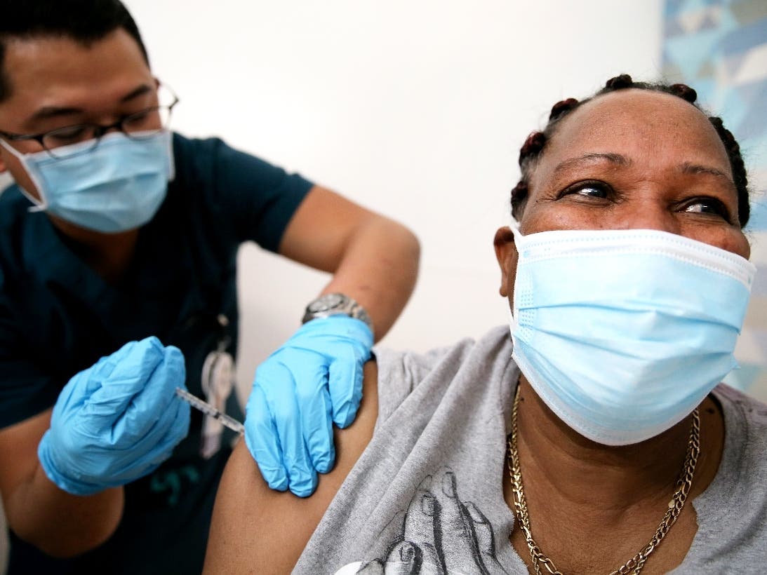  FEBRUARY 25: Lorraine Harvey, an in-home care worker, receives her first dose of the COVID-19 vaccine from registered nurse Rudolfo Garcia at a clinic at Martin Luther King Jr. Community Hospital in South Los Angeles on February 25, 2021 in Los Angeles.