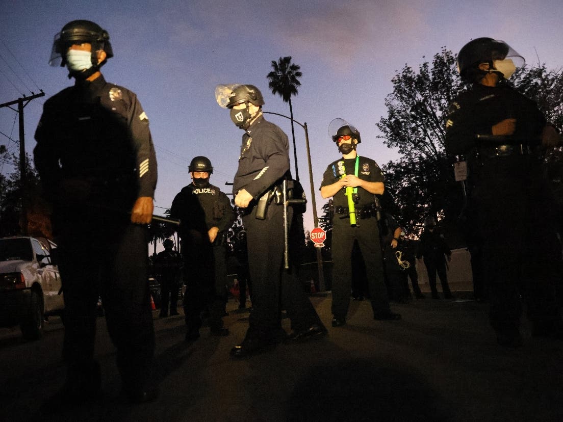 MARCH 25: LAPD officers block the street near Echo Park Lake as protesters demonstrate nearby against the removal of a homeless encampment on March 25, 2021 in Los Angeles, California. 
