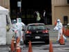 Medical personnel surround a car that is going through a coronavirus drive-thru test clinic at the San Mateo County Event Center on March 16, 2020 in San Mateo, California. 