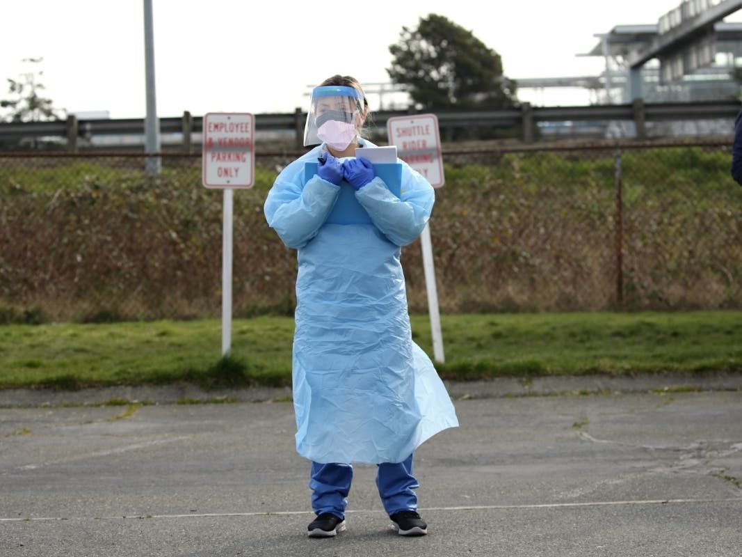 Medical assistant Mirian Fuentes waits for patients to arrive for a COVID-19 screening at an appointment-only, drive-up clinic set up by the University of Washington Medical Center Northwest Outpatient Medical Center on March 17, 2020 in Seattle, WA.