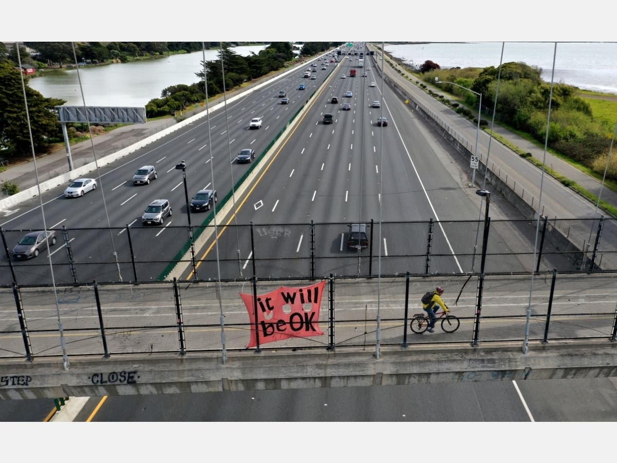 A banner saying that "it will be ok" hangs from an overpass along Interstate 80 on March 17, 2020 in Berkeley, California. 