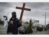 Activist Matt Harper, with community group The Los Angeles Catholic Worker, livestreams from his phone as he re-enacts the Stations of the Cross alone amidst the coronavirus pandemic on April 10, 2020 in Los Angeles, California.