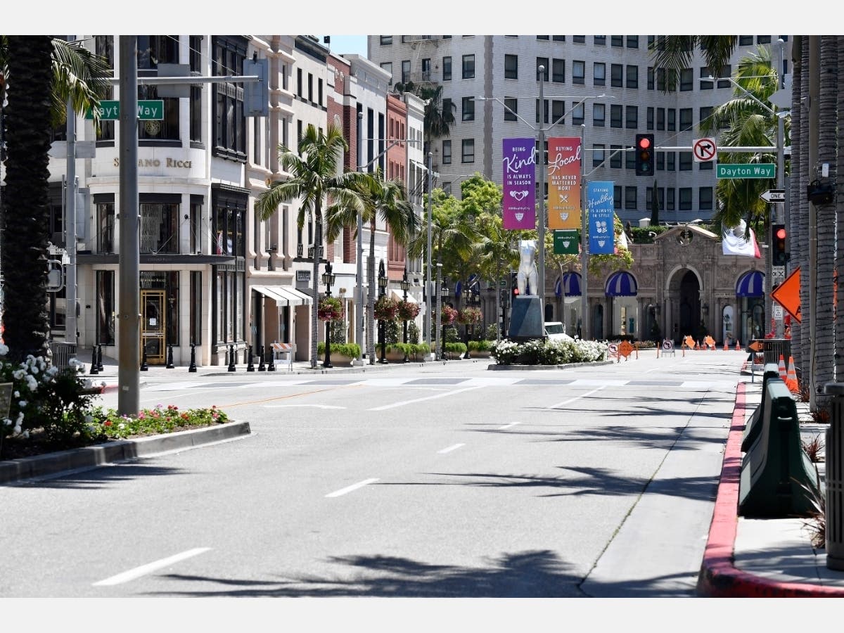 Campaign banners to prevent the spread of COVID-19 are seen on a deserted Rodeo Drive during the COVID-19 lockdown on April 22, 2020 in Beverly Hills, California.