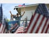 U.S. Army World War II veteran Lt. Colonel Sam Sachs, who turned 105 Sunday, holds an American flag at his drive-by birthday party amid the coronavirus pandemic on April 26 in Lakewood, Callifornia.