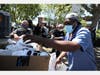 Pastor Lawrence VanHook prepares to pass out health care packages to homeless people at Union Plaza Park on April 28, 2020 in Oakland, California.