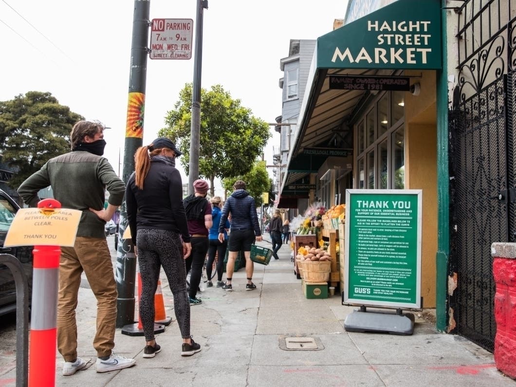 People line up to enter a market Saturday in San Francisco, California.