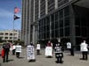 Faith leaders and activists hold signs and tombstone shapes as they hold a public memorial in front of the Phillip Burton Federal Building and U.S. Courthouse to honor victims of COVID-19 that have died while incarcerated on May 12, 2020 in San Francisco.
