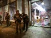 Law enforcement from the King County Sheriffs office momentarily guard a store during riot following a peaceful rally expressing outrage over the death of George Floyd on May 30, 2020 in Seattle, Washington.