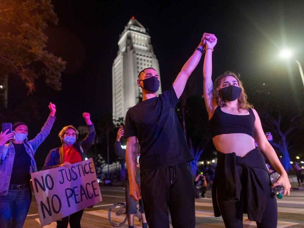 Protesters confront police near City Hall as demonstrations continue over the killing of George Floyd despite the dangers of the widening coronavirus (COVID-19) pandemic on June 6, 2020 in Los Angeles, United States. 