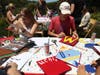 Redwood High School seniors Ava Coven (L) and Charlie Tantum (R) work on their graduation caps on June 09, 2020 in Tiburon, California. As concerns over coronavirus COVID-19 continue, seniors at Redwood are preparing for a parking-lot graduation.