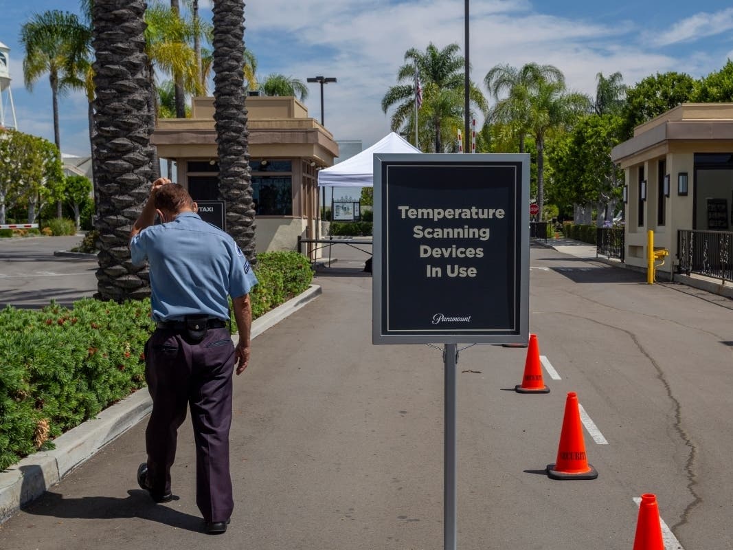 A security guard walks outside Paramount Pictures Studios as Los Angeles County allows more businesses and facilities to reopen today, despite rising COVID-19 infections and deaths on June 12, 2020 in Los Angeles, California.
