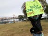 Tesla worker Carlos Gabriel holds a sign during a demonstration outside of the Tesla factory on June 15, 2020 in Fremont. A handful of Tesla workers protested to demand that Gov. Gavin Newsom send inspectors to examine working conditions.