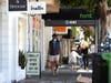 A pedestrian walks by a retail store that has reopened on June 16, 2020 in San Francisco, California. According to a report by the U.S. Commerce Department, retail sales surged 17.7 percent in May as more states begin the process of reopening.