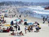 People gather on Santa Monica beach amid the COVID-19 pandemic on July 02, 2020 in Santa Monica, California. Beginning July 3, Los Angeles County beaches and piers will be closed through the July 4th holiday weekend.