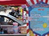 Stacee Hoffee helps a customer during a drive-thru food fair in the parking lot at the Veterans’ Memorial Auditorium on July 10, 2020 in San Rafael, California. With county fairs being canceled across the United States, Marin set up a drive-thru version.