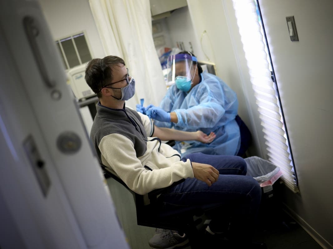 A man has his blood drawn for an antibody test for the coronavirus, also called a serology test. A new report says a record 5.4 million Americans have lost health insurance amid the coronavirus pandemic.