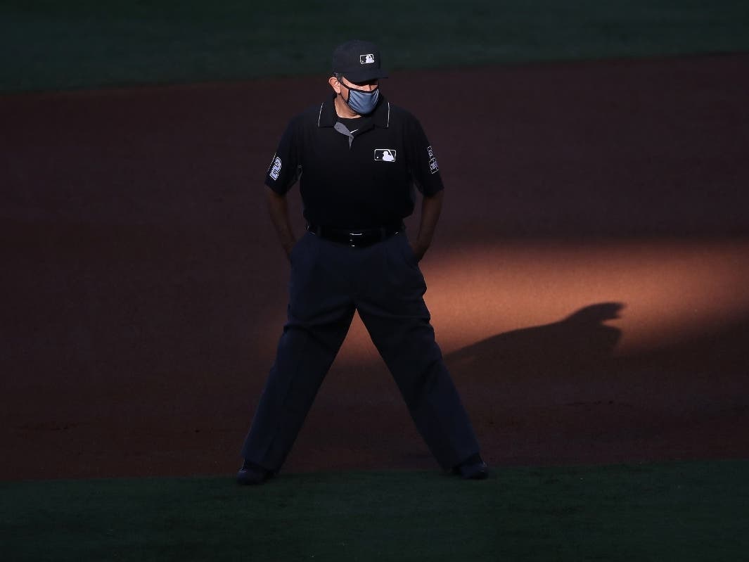 Umpire Alfonso Marquez #72 looks on during the first inning of a game between the Los Angeles Angels and the Houston Astros at Angel Stadium of Anaheim on July 31, 2020 in Anaheim, California.
