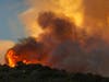 Flames and heavy smoke approach on a western front of the Apple Fire, consuming brush and forest at a high rate of speed during an excessive heat warning on August 1, 2020 in Cherry Valley, California.